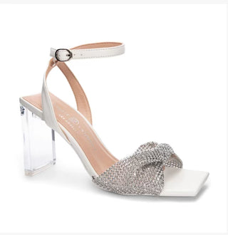 A white strap with clear heel and rhinestone bow on open toe strap