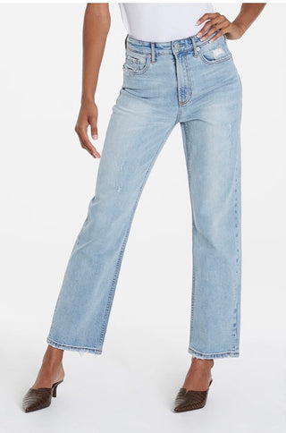 A pair of light blue, high-waisted, distressed skinny jeans on a female mannequin.