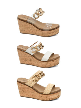 A selection of three On Vacay Corkys sandals, featuring cork heels and straps in different colors: Clear, Ivory and Raffia.