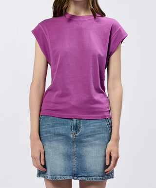 Person wearing a purple t-shirt and denim skirt on a white background