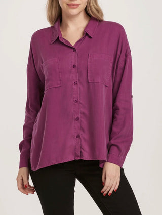 Purple button-up shirt worn by a person on a plain background