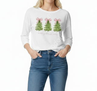 Person wearing a white long-sleeve shirt with Christmas tree design and jeans on a white background