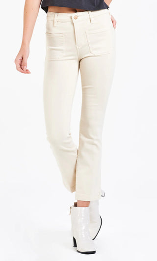 A pair of beige skinny jeans, displayed on a model without showing the upper part of the body.