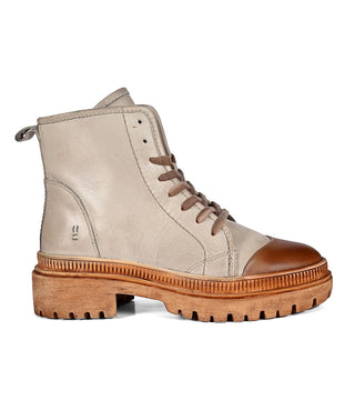 A brown almond bone colored shoe with a lace-up closure and a flat sole.