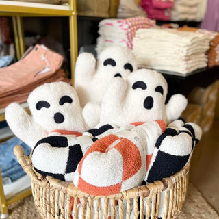 A cozy blanket with a checkered pattern displayed in a wicker basket, with the blanket's size 50 X 60 inches visible.
