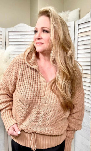 woman with a taupe crochet sweater with hoodie