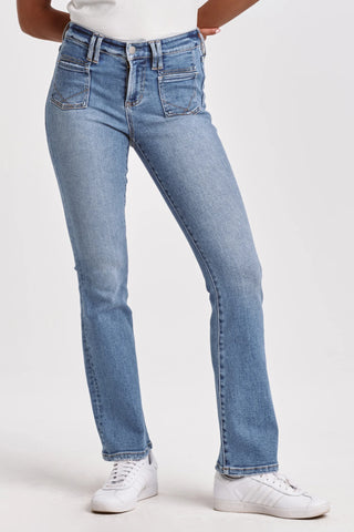 Person wearing light blue jeans and white sneakers on a white background
