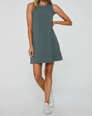Woman wearing a green sleeveless dress on a white background