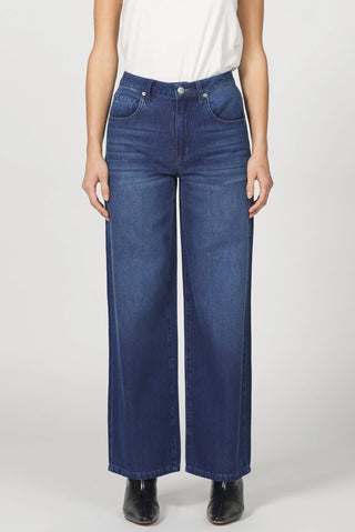 Person wearing blue jeans on a white background