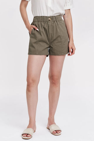 Person wearing olive green shorts on a white background