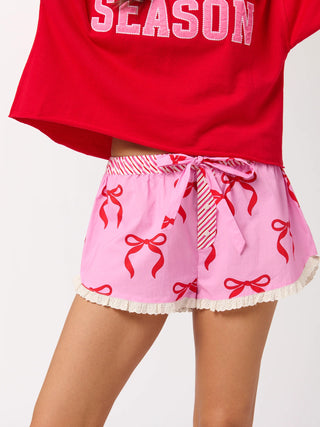 Girl wearing boxer shorts with pink and red candy canes