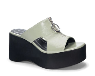 Green platform sandals with black bottom and a silver zipper on top