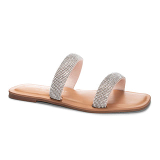 A pair of Chinese Laundry Zailey Puff Stone Nude sandals with a metallic stone-like pattern on the strap and a brown footbed.