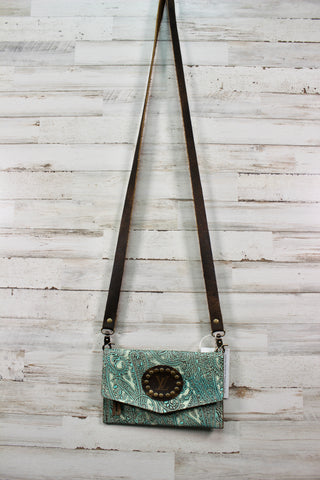 Upcycled cross body purse with teal and light blue accents with dark brown leather strap.
