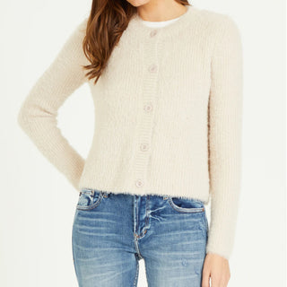 Fuzzy button up taupe sweater paired with light blue denim jeans