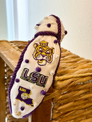 LSU Tigers themed headband resting on a wicker basket.
