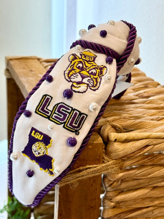 LSU Tigers themed headband resting on a wicker basket.