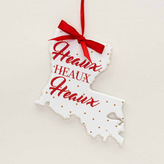 Ornament with red writing that says “heaux, heaux, heaux”