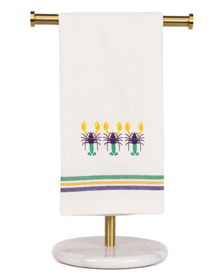 White towel with lobster design on a stand against a white background