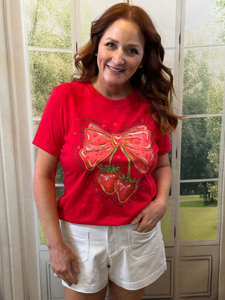 Red shirt with bow and strawberry design.
