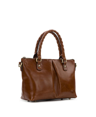 A brown leather handbag with braided top handles, gold-tone hardware, and a front flap detail, photographed on a clean white background.