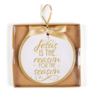 Ornament with gold writing that says “Jesus Is The Reason For The Season”