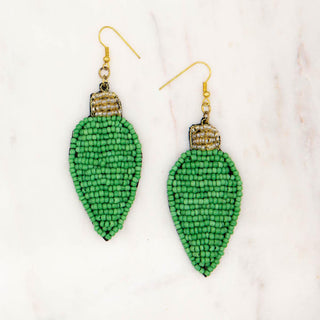Green beaded earrings on a light background
