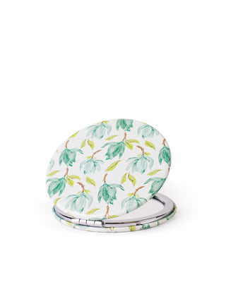 Compact mirror with green leaf pattern on a white background