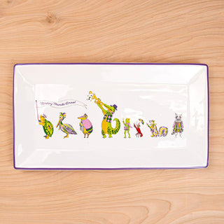 Rectangular plate with colorful animal illustrations on a wooden surface