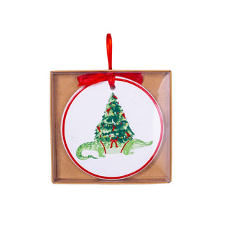 Decorative plate with a Christmas tree design, framed in wood and tied with a red ribbon.