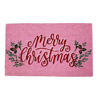 Pink doormat with red writing that says “Merry Christmas”