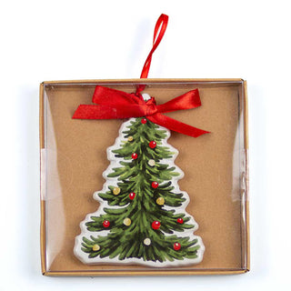 Christmas tree ornament with red berries in a box with a red ribbon on a white background