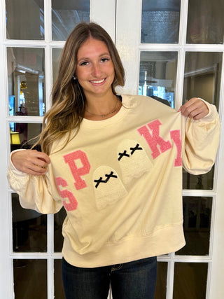 Cream sweatshirt with the word, spooky￼ on the front