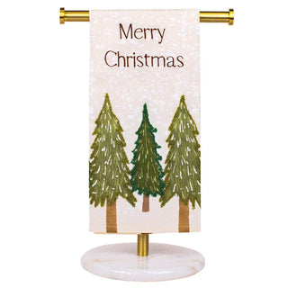 Decorative towel with Christmas trees and 'Merry Christmas' text on a stand.