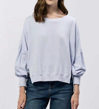Light blue oversized sweatshirt worn by a person on a white background