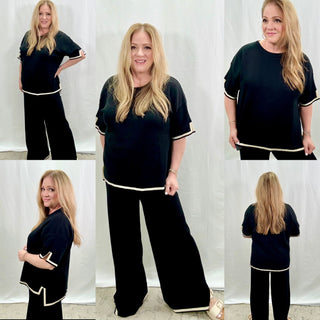 Woman modeling a black outfit with white trim in various poses against a white background