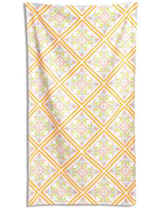 Patterned towel with orange and green design on a white background