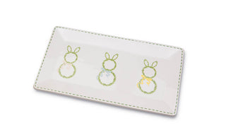 White cardholder with embroidered bunny designs on a white background