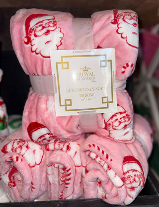 Pink blanket with red candy canes and Santa Clauses 