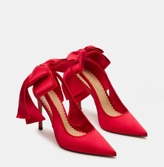 Red satin pointed toe heels with red bows on the back 