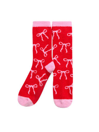 Red socks with white bow pattern on a white background