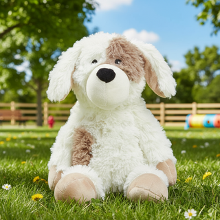 Plush dog toy sitting on grass with a park background