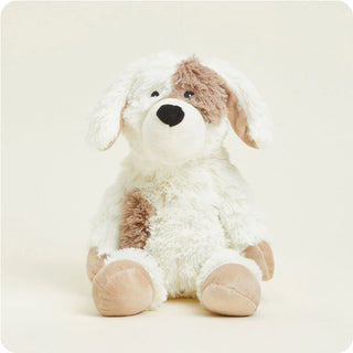 Plush dog toy with white and brown fur on a light beige background
