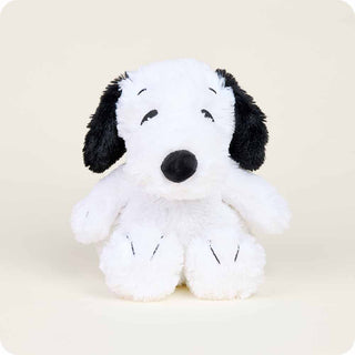 Plush toy resembling a black and white dog on a beige background