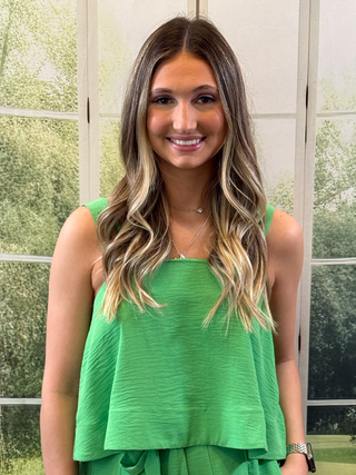 Woman wearing green flowy tank top
