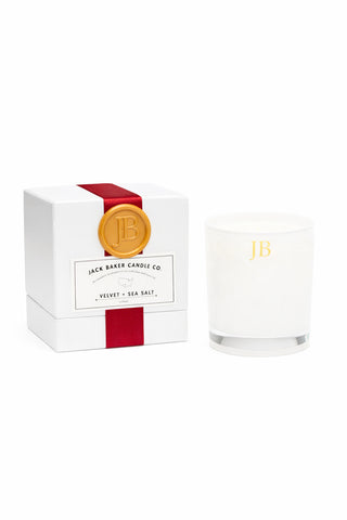Candle with packaging featuring Jack Baker Candle Co branding on a white background