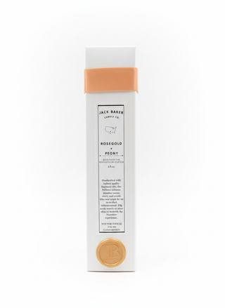 Jack Baker Candle Co. candle packaging with rose gold and peach accents on a white background