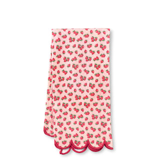 Pink towel with strawberry pattern on a white background