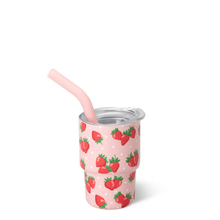 Pink tumbler with strawberry pattern and straw on a white background